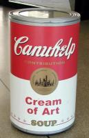 Large barrel made to look like a Campbell Soup Can, labelled “Canuhelp Cream of Art Soup