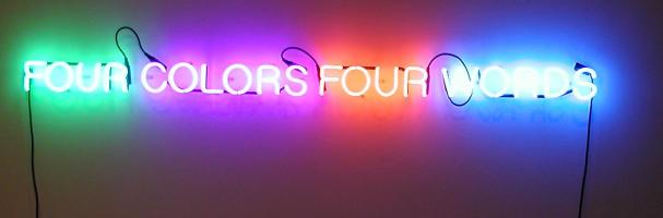 Neon lights spelling out “FOUR COLORS FOUR WORDS” with each word in a different color.