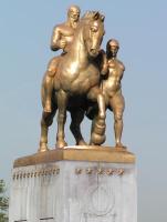 Statue on bridge; man on horseback next to standing man.