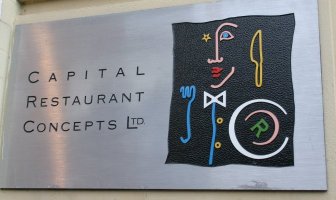 Logo for restaurant with silhouette composed of utensils