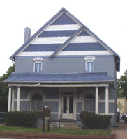 House with blue striped pattern on second story