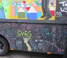 Truck decorated with chalk drawings by passers-by.