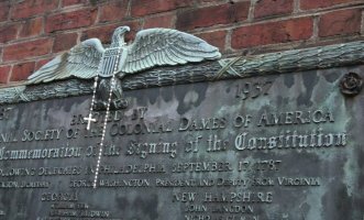 cross hanging over plaque commemorating constitution