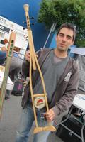 man holding banjo made out of a crutch